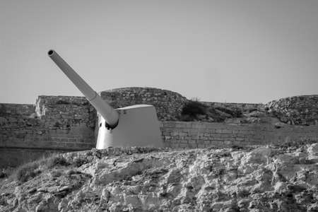 An old ship cannon on a hill, mountain