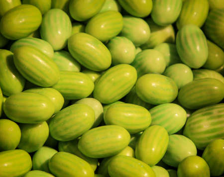 Many chewy candies that are shaped and colored like melons.の写真素材