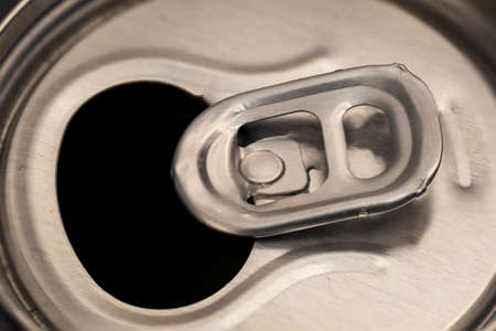The lid of an aluminum beverage can from above.