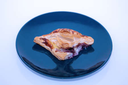 A piece of Danish pastry on a plateの写真素材