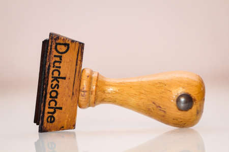 A wooden stamp for printed matter