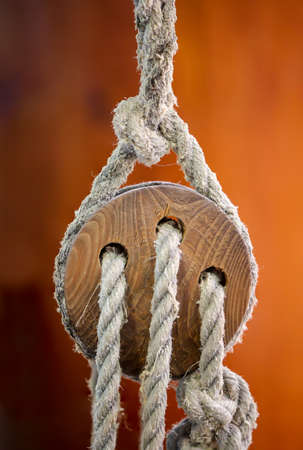 A detail of a sailboat. Here a so-called three-holed maiden, rope pulley.