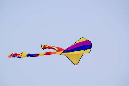 A colorful stunt kite, kite with colorful tails in the sky.の写真素材
