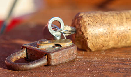 A key for a lock, padlock with a cork tag.