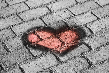 A heart on a brick surface. Heart texture.の写真素材