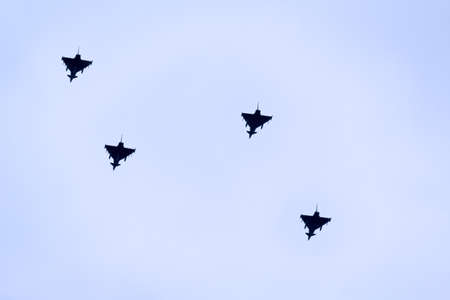 Four fighter planes flying in formation, maybe four Eurofighters.の写真素材