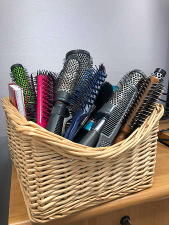 Lots of brushes, combs and scissors a hairdresser at his workplace.の写真素材