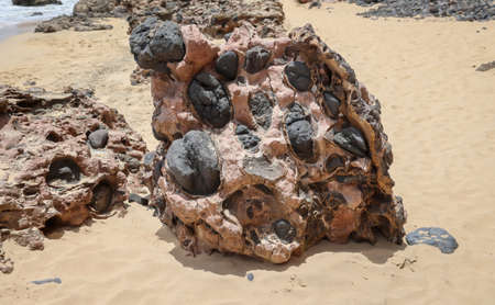 A rock with inclusions. Origin is volcanic activity.