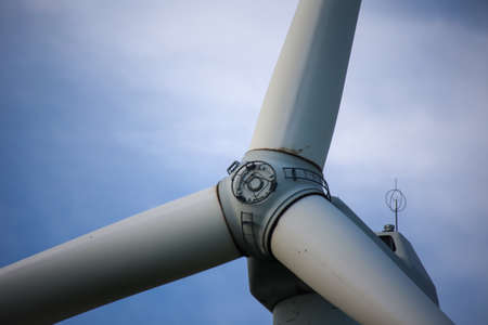 Close-up of the hub of a wind turbine. Blade and hub of a wind turbine.