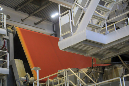 Industrial machinery and equipment in a factory, closeup of photo. Detail of a large machine, an industrial plant for the manufacture of products. Huge conveyor belts.の写真素材
