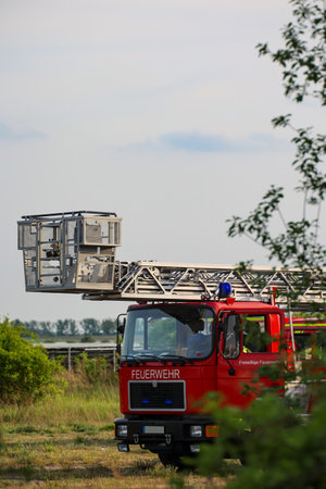 Fire truck in action during a firefighting operation on a summer day. Detail of a fire engine with...