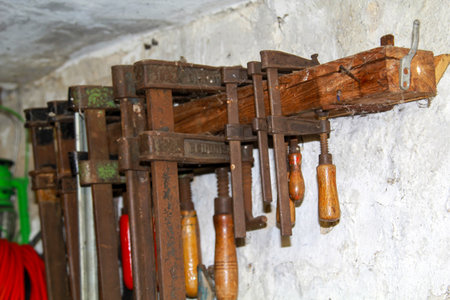 Old screw clamps in a workshop.の写真素材