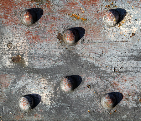 Steel girder with rivets. rusty metal plate with rivets in the old iron door backgroundの写真素材