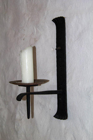A candlestick on a wall.の写真素材