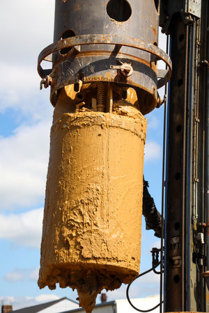 A caisson in use on a building site, for the construction of a foundation. Close up of the part of an oil well in a field.の写真素材