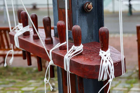 Details of a cutter, a ship, a sailing ship. Wooden mooring ropes on the deck of a sailing shipの写真素材
