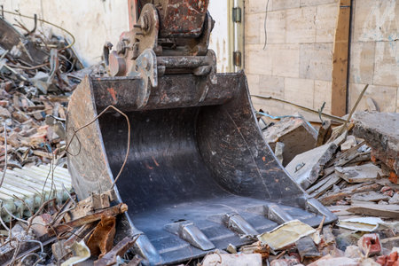 Detail of an excavator at a construction site. Demolition of a building with an excavator, close-upの写真素材
