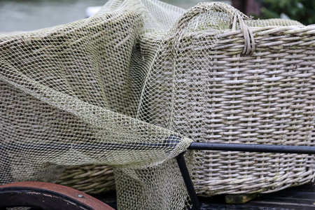 Old utensils from a fish market. fishing net on a boat, detail of a fishing net on a boatの写真素材