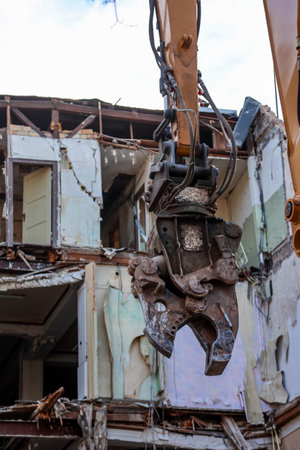 Detail of an excavator at a construction site. Demolition of an old house. Demolition of an old house.の写真素材
