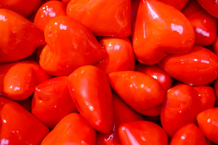 Many red glass hearts in a bowl.の写真素材