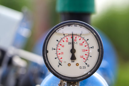 A pressure gauge on an industrial plant. Closeup of photo.