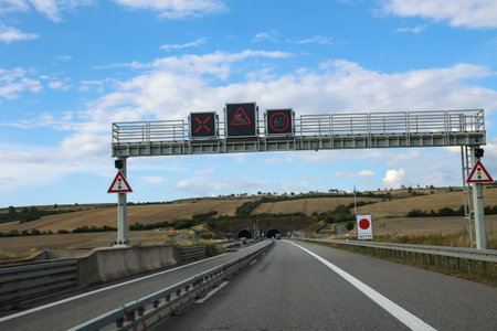 Highway in the countryside, with traffic signs and road markings.