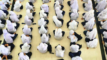 muslim pupil sitting on floorの写真素材
