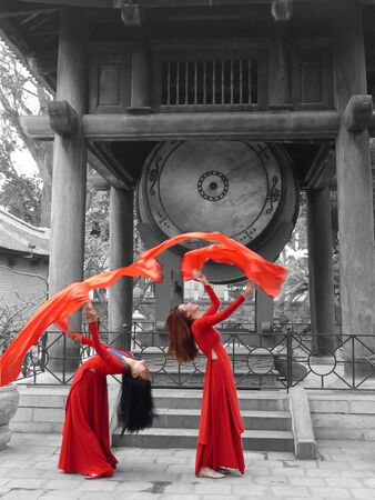 two dancers in front of historical drums in temple of literatureのeditorial素材