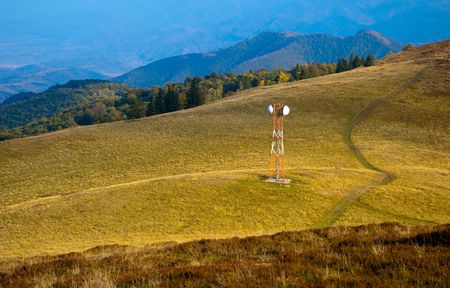Telecommunication antenna (GSM) on mountain meadow pictured in autumnの写真素材