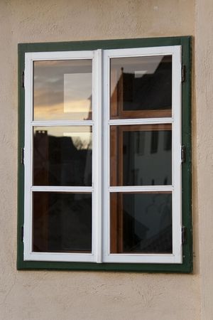 wooden window at dusk reflection in old town of sibiu