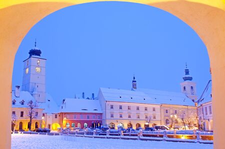 Winter in old town center Sibiu, small square (Piata Mica) all building covered with snowの写真素材
