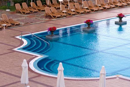 Swimming pool with deckchairs at luxury hotelのeditorial素材