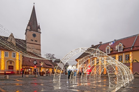 Winter night cityscape with Christmas decoration in the historic center of Cisnadie (Sibiu county), Transylvania, Romaniaのeditorial素材