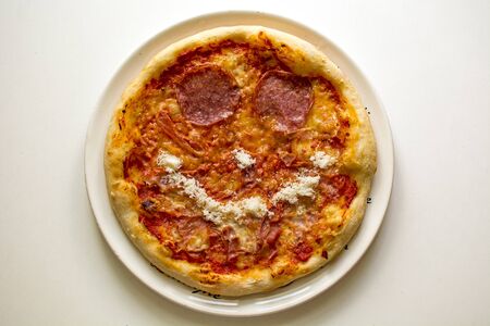 Pizza smile with salami and prosciutto cottoの写真素材