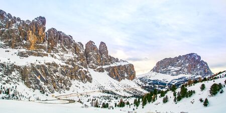 Passo Gardena on Sella Ronda ski circuit around the Sella group in Northern Italy, Trentino / Alto Adige / Belluno, Italy, Gruppo Sella to the left, Sassolungo - rightの写真素材