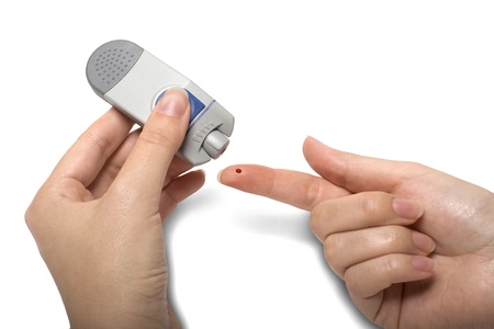 Testing Blood Sugar with Diabetic Glocumeter Isolatedの写真素材