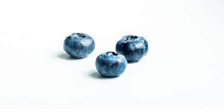 Fresh three blueberries isolated on white background closeupの写真素材