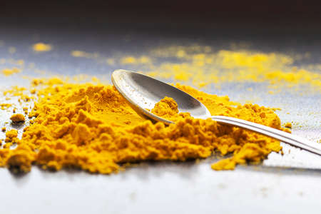 spice in spoon over gray table background. Top view with copy spaceの写真素材