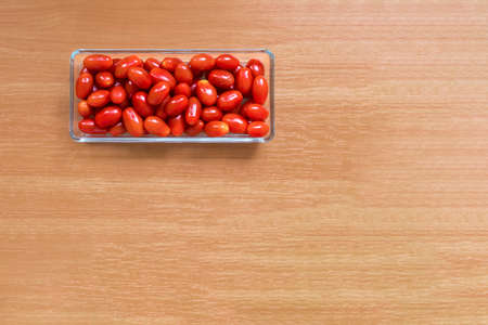 Red round cherry tomatoes in glassware. Natural product. Copy spaceの写真素材