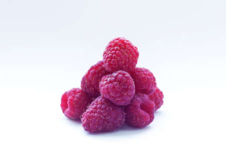Fresh raspberry isolated over white background. Close up macro shot. Selective focus.
