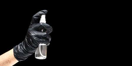 Close up view of human hand and antiseptic spray on black background. Hand sanitation. Epidemic control. Prevention of coronavirus. Banner.の写真素材