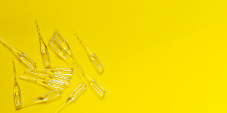 Ampoules, vaccine isolated on yellowの写真素材