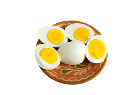 Boiled eggs on a plate on a white backgroundの写真素材