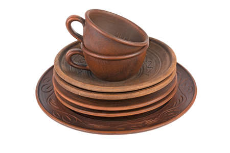 pottery, round clay dish and handmade cup isolated on white backgroundの写真素材