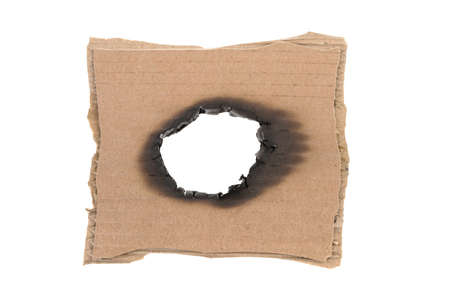 a piece of cardboard is burned out on a white backgroundの写真素材