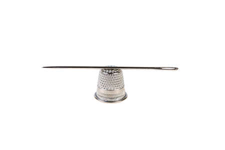 thimble and needle on white background