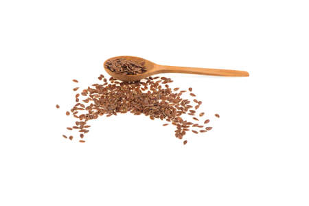 flax seeds on wooden spoon isolated on white backgroundの写真素材