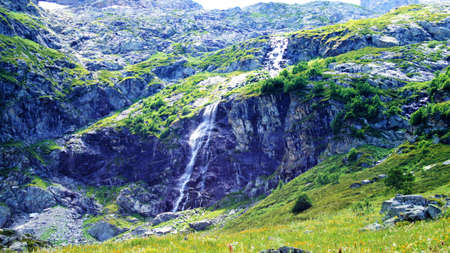 The beautiful mountain waterfall among the rocks in a wild place,の写真素材
