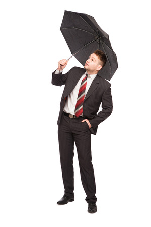 elegant man with umbrella looking up on white backgroundの写真素材