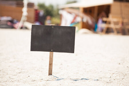 wooden signboard on sand beachの写真素材